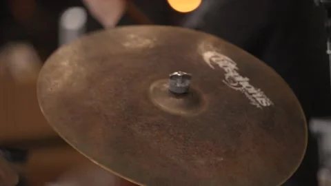 Slow motion close up of drumsticks hitting shaking cymbal, zoom out Stock Footage 204765345
