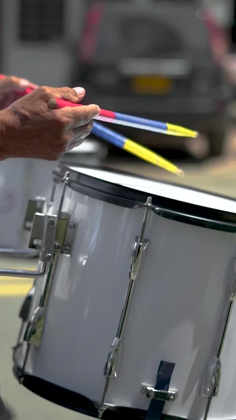 Slow-motion close-up of elderly hands playing side drum in marching band. Stock Footage 282992258