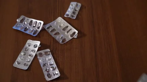 Slow motion Close up of empty blister pack of pills being thrown onto table Vidéo 130187768