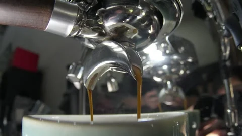 Slow Motion Close-Up of Espresso Extracting Into Cup From Cafe Espresso Machine Stock Footage 334850086
