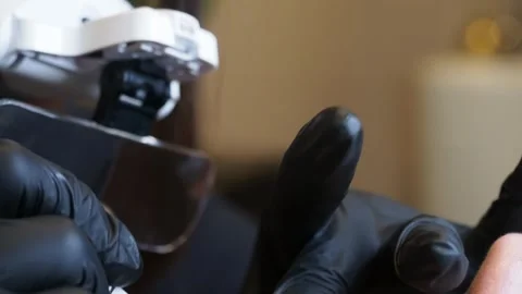 Slow motion close-up of esthetician's gloved hands during microblading Stock Footage 307483849