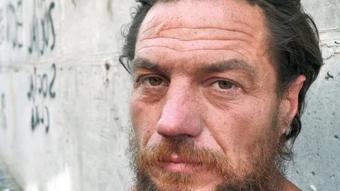 Slow motion close-up face of real homeless man 動画素材 113150136