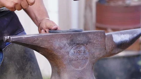 Slow motion close up of a Farrier hammering a horseshoe into shape on an Stock Footage 104319205