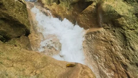 Slow motion close up of a fast flowing mountain waterfall Video stock 321325900