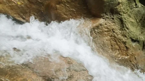 Slow motion close up of a fast flowing mountain waterfall Stock Footage 321325942
