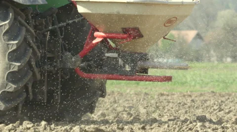 SLOW MOTION CLOSE UP: Fertilizing field with manure with tractor Stock Footage 49580219