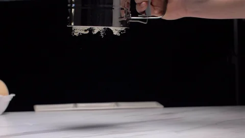 Slow Motion. Close-up of a flour through a sieve fray. Stock Footage 103307475