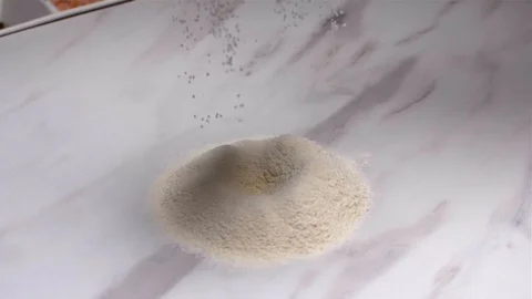 Slow Motion. Close-up of a flour through a sieve fray. Vídeos de archivo 103308712