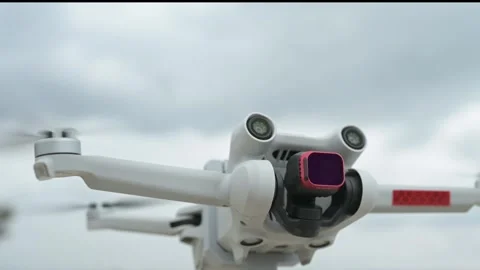 Slow motion close-up of a flying drone with spinning propellers and glowing Video stock 319557053