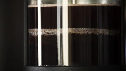 Slow motion close up of French Press pushed down by filter Stock Footage 82459353