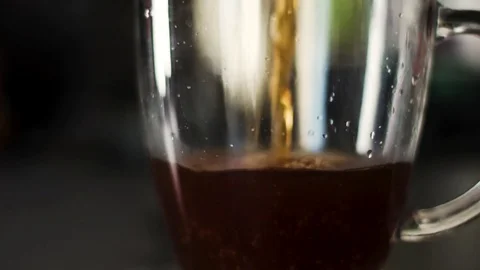 Slow motion close up of glass cup being filled with fresh coffee Stock Footage 82459809