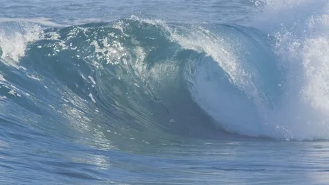 SLOW MOTION CLOSE UP: Glassy ocean wave forming a perfect tube form on sunny day Stock Footage 84502171