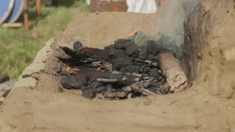 Slow motion close-up of glowing charcoal in blacksmith forge fire Stock Footage 319947323