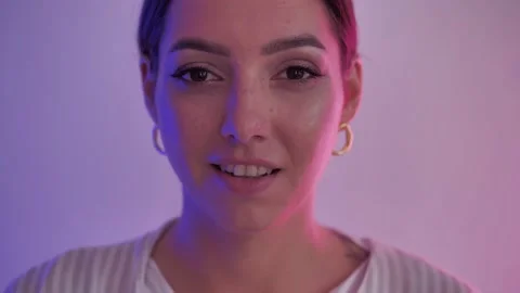 Slow Motion Close Up Of gorgeous young Woman Looking At Camera and smiling Under Stock Footage 148319468