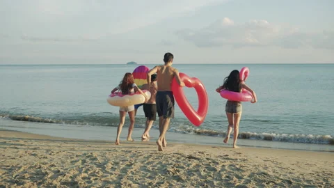 Slow motion: Close up group friends running enjoy life playing and freedom beach Stock Footage 143547415