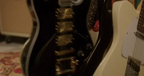 Slow Motion Close-up of Guitar Being Picked From Guitar Stand LUT Stock-Footage 323476940
