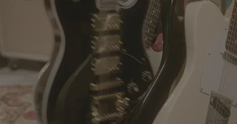 Slow Motion Close-up of Guitar Being Picked From Guitar Stand Stock-Footage 323476945