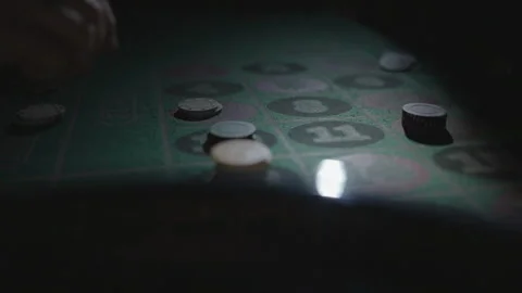 Slow motion close-up hand distributing chips on number Stock Footage 335700024