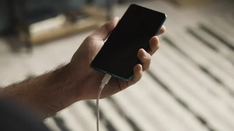 Slow Motion Close Up of Hand Plugging and Unplugging USB-C Cable Into Smartphone Vídeos de archivo 343451347
