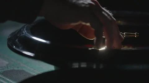 Slow motion close-up hand spinning roulette off-center 스톡 동영상 335700030