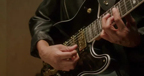Slow Motion Close-Up of Hand Strumming Electric Guitar LUT Stock-Footage 323975049