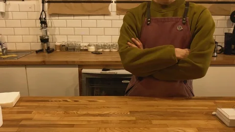 Slow motion. Close up hands of barista. Barista in a green sweatshirt and purple Video stock 123552579