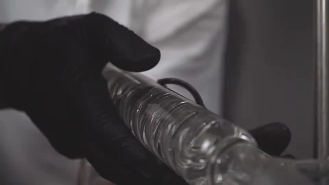 Slow motion close up of hands in black gloves setting up extractor  in lab Stock Footage 133254110