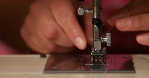 Slow Motion Close-up Hands of Person Adding Thread to Sewing Machine Stock Footage 104499264