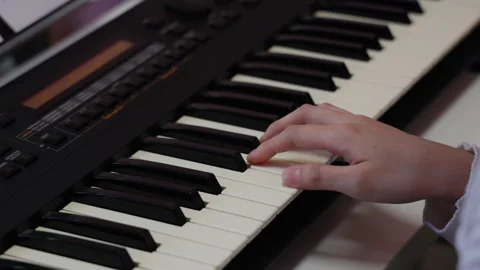 Slow motion close up of hands playing a keyboard piano Video stock 348400996