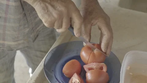 Slow Motion Close-up of Hands Removing Seeds from Freshly Harvested Tomato Stock Footage 320634532
