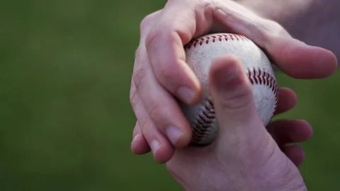 Slow motion close-up of hands rubbing baseball Stock Footage 85581043