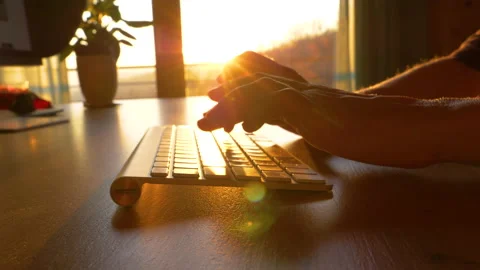 SLOW MOTION CLOSE UP Hands working and typing on computer keyboard early morning Video stock 191735626
