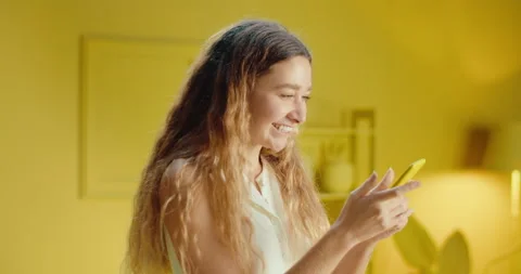 Slow motion close up of happy smiling woman watching social media in a Stock-Footage 188098661