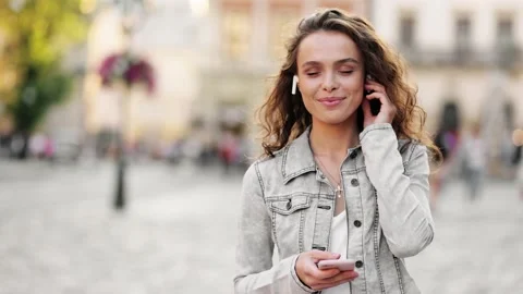 Slow motion close up of happy young woman enjoying music dancing in the street Stock Footage 139363464