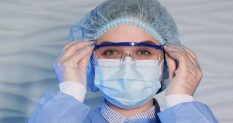 Slow motion close-up high key light shot of microbiologist  protective wear Video stock 152760549