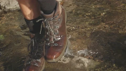 Slow Motion Close up hiking through a rocky river Stock Footage 152426554