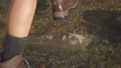Slow Motion Close up hiking through a rocky river Video stock 152426999