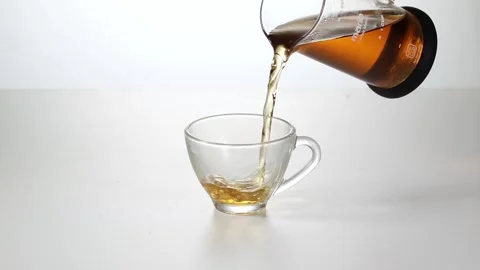 Slow Motion Close Up of Hot Black Tea Pouring into Glass Cup Stock Footage 342497573