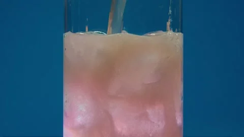 Slow motion close-up of Ice Cubes falling into an empty transparent Glass. The Stock Footage 246977708