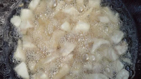 Slow motion close-up of lamb tail fat rendering in cauldron during first st.. Stock Footage 319661125