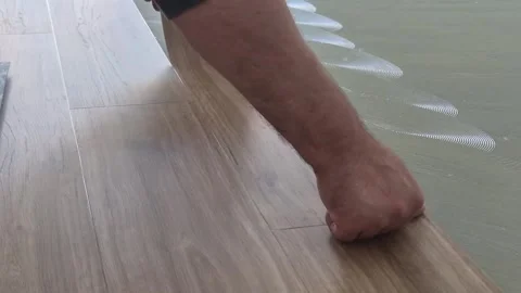 Slow Motion Close-up of Laying Vinyl Floor Plank 库存影片 334334965