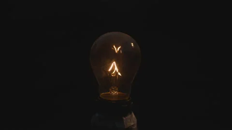 Slow motion close up of a lightbulb filament overheating and burning Stock Footage 63627611
