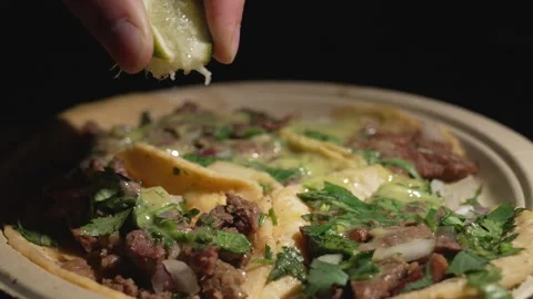 Slow motion close up lime squeezed on tacos Stock Footage 250357964