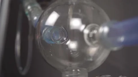 Slow motion close up of liquid running through apparatus in lab Stock Footage 133253878