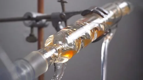 Slow motion close up of liquid running through apparatus in chemistry lab Stock Footage 133253963