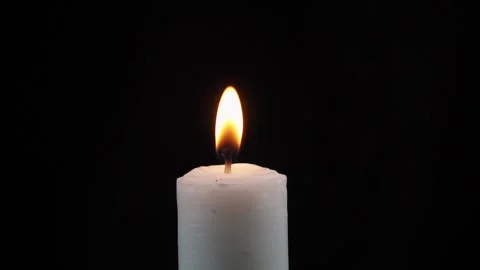 Slow motion close up of lit candle isolated black background Stock Footage 279039613
