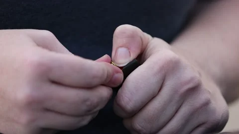 Slow Motion Close Up of Loading 9mm Gun Magazine - Shallow Depth of Field Stock Footage 159464507