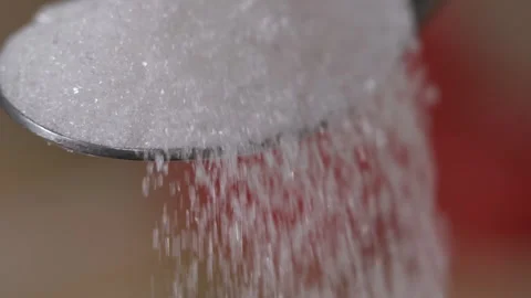 Slow Motion Close Up Locked Down Shot of White Sugar Crystals Falling Off Spo Stock Footage 157039259
