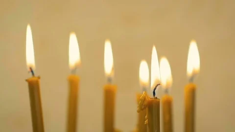 SLOW MOTION: close-up of a lot of beautiful wax candles burning. Stock Footage 82297333