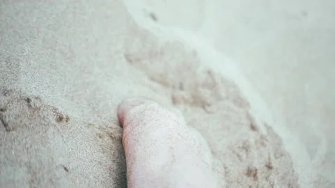 SLOW MOTION, CLOSE UP, LOW ANGLE, Male foot in the sand and causing sand to fly Stock Footage 199229919